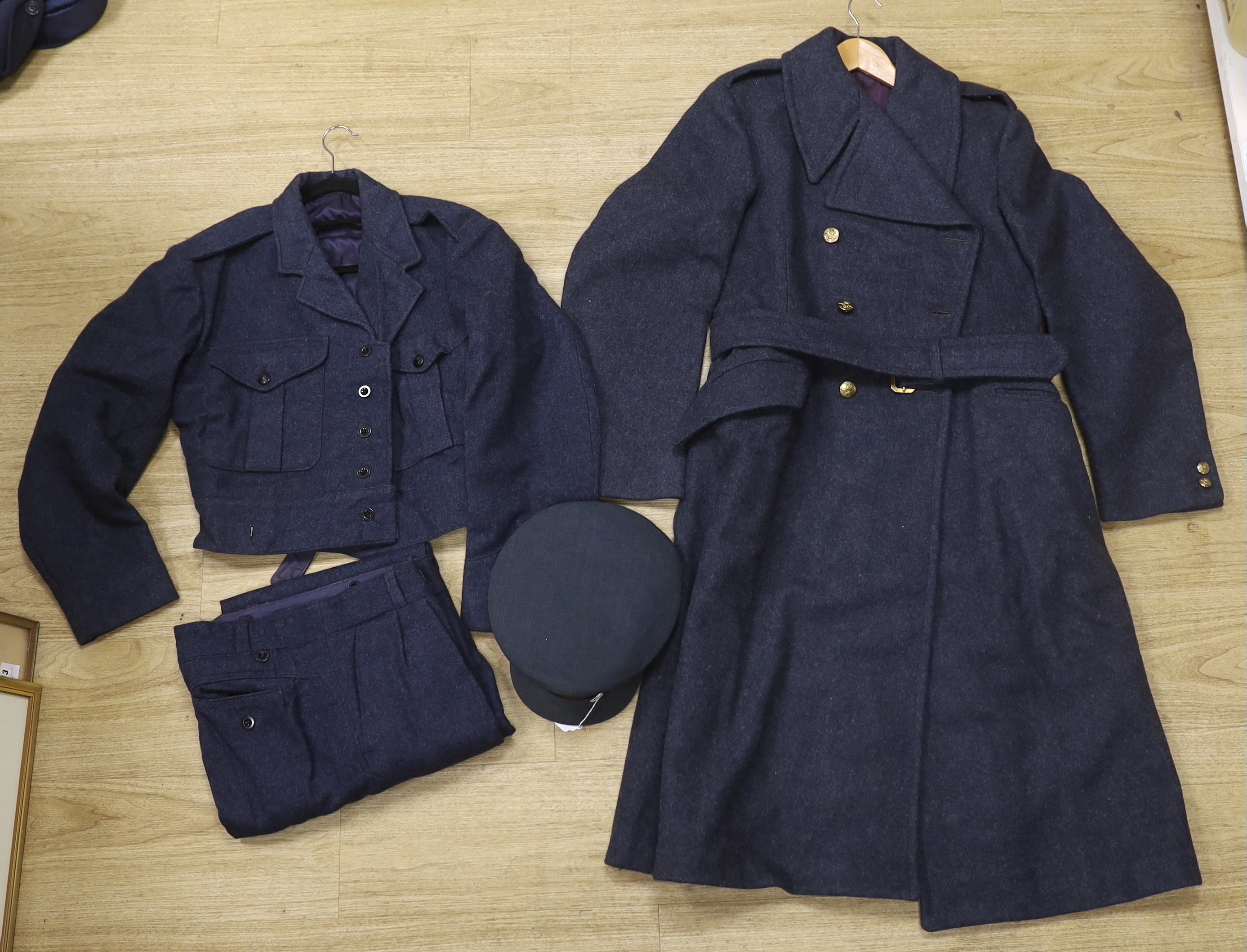 A 1960s RAF uniform comprising; great coat, blouse, cap and trousers, all with manufacturer’s labels, broad arrow markings, dates, etc.